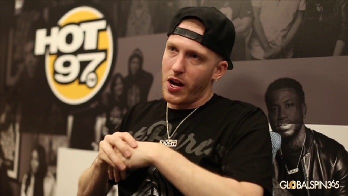 A picture of DJ Drewski in his black t-shirt and cap on Radio Hot 97